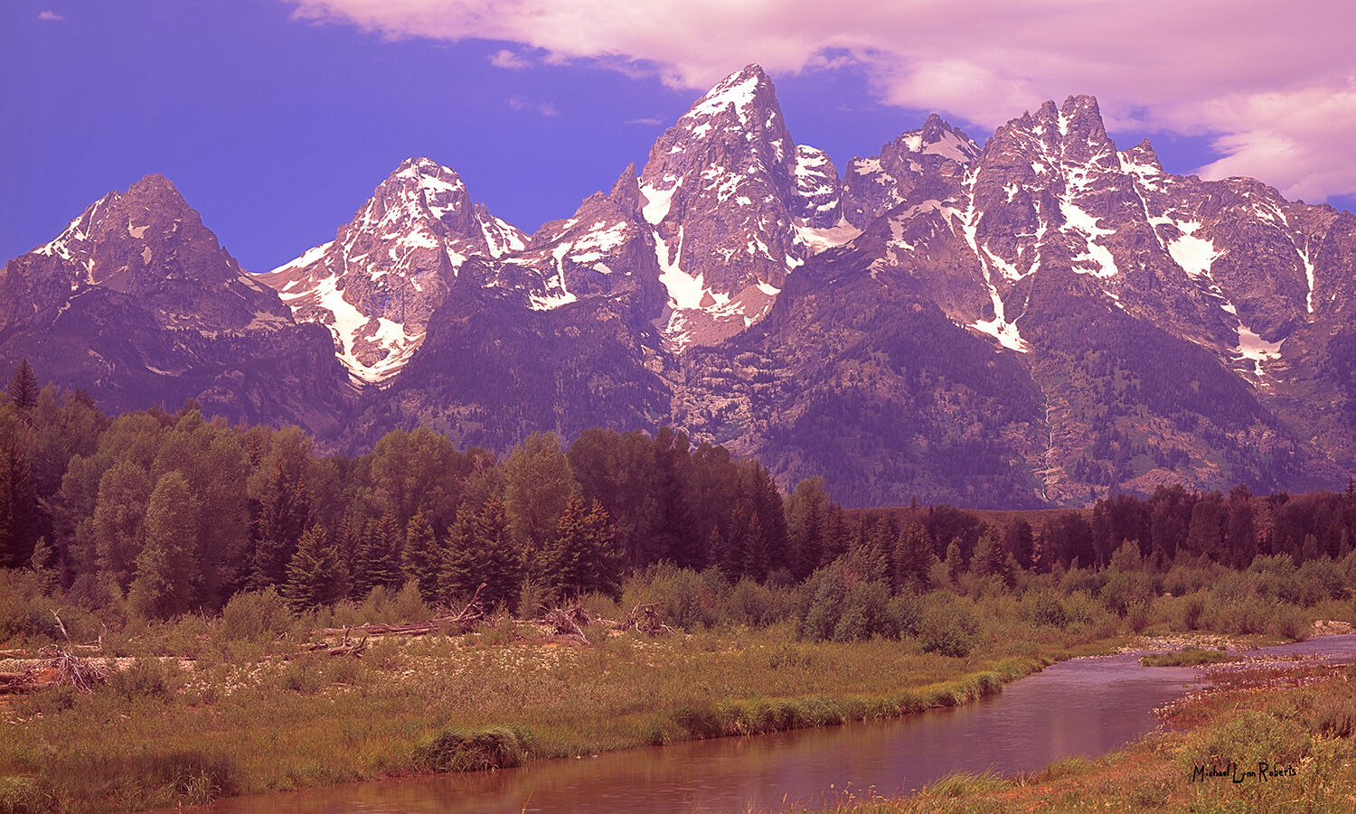 Teewinot Mountain (left), Grand Teton (middle), and Mount Owen (right) rise dramatically above the Jackson Hole valley, bringing...
